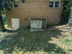 This image shows an HVAC with overgrowth after brush removal.