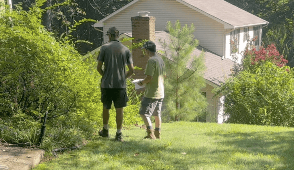 Team members Shawn and Chris reviewing plans for landscape restoration project in Hixson.
