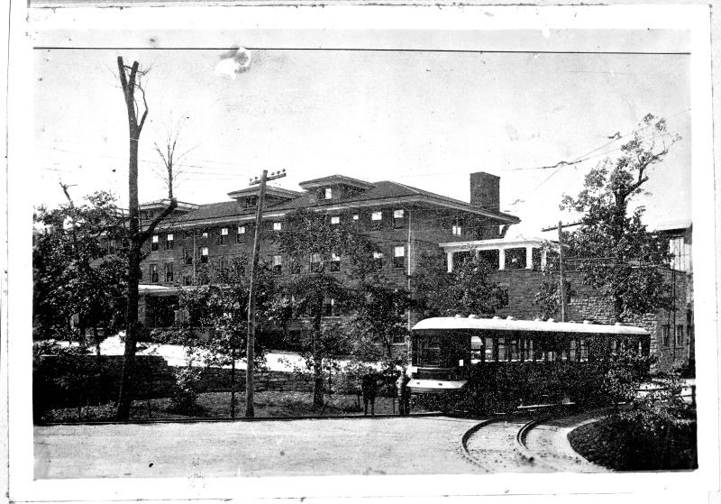 Signal Mountain Inn, built by C. E. James in 1912, and located at 100 James Boulevard in Signal Mountain, Tennessee. A streetcar is in front of the building.