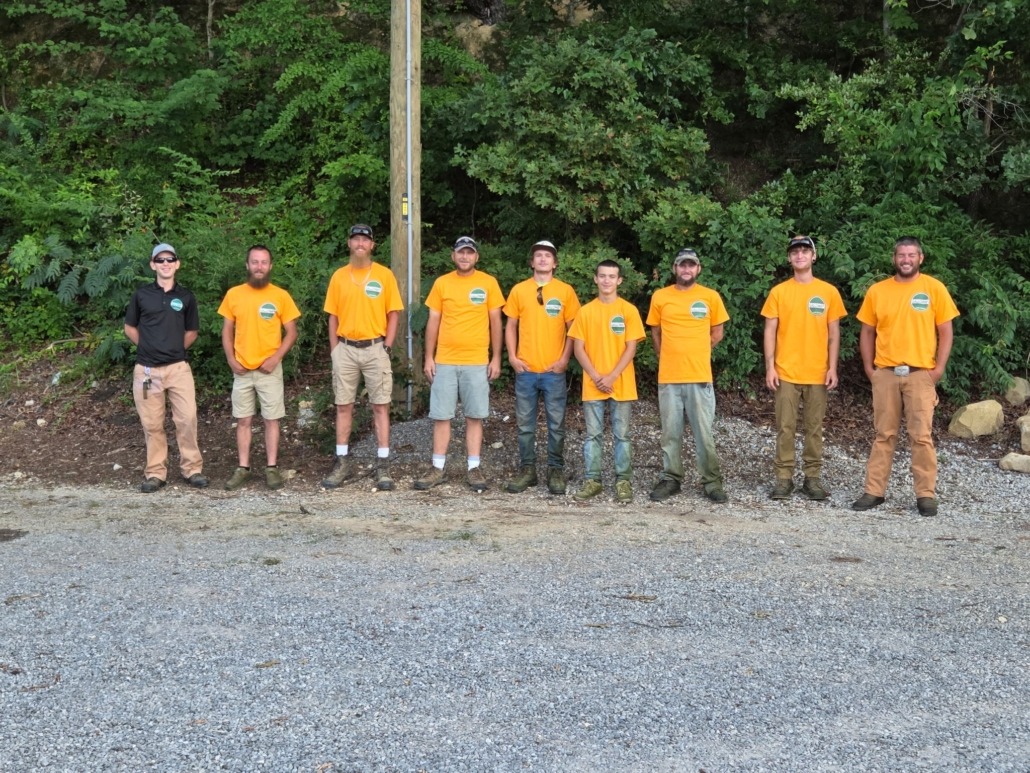 a group of men in orange shirts