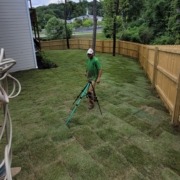 Josh and the team setting up sprinklers to water freshly installed sod grass in Hixson, TN