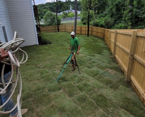 Josh and the team setting up sprinklers to water freshly installed sod grass in Hixson, TN