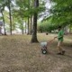 A member of The Galloway Team spreading grass seed in a Chattanooga yard.